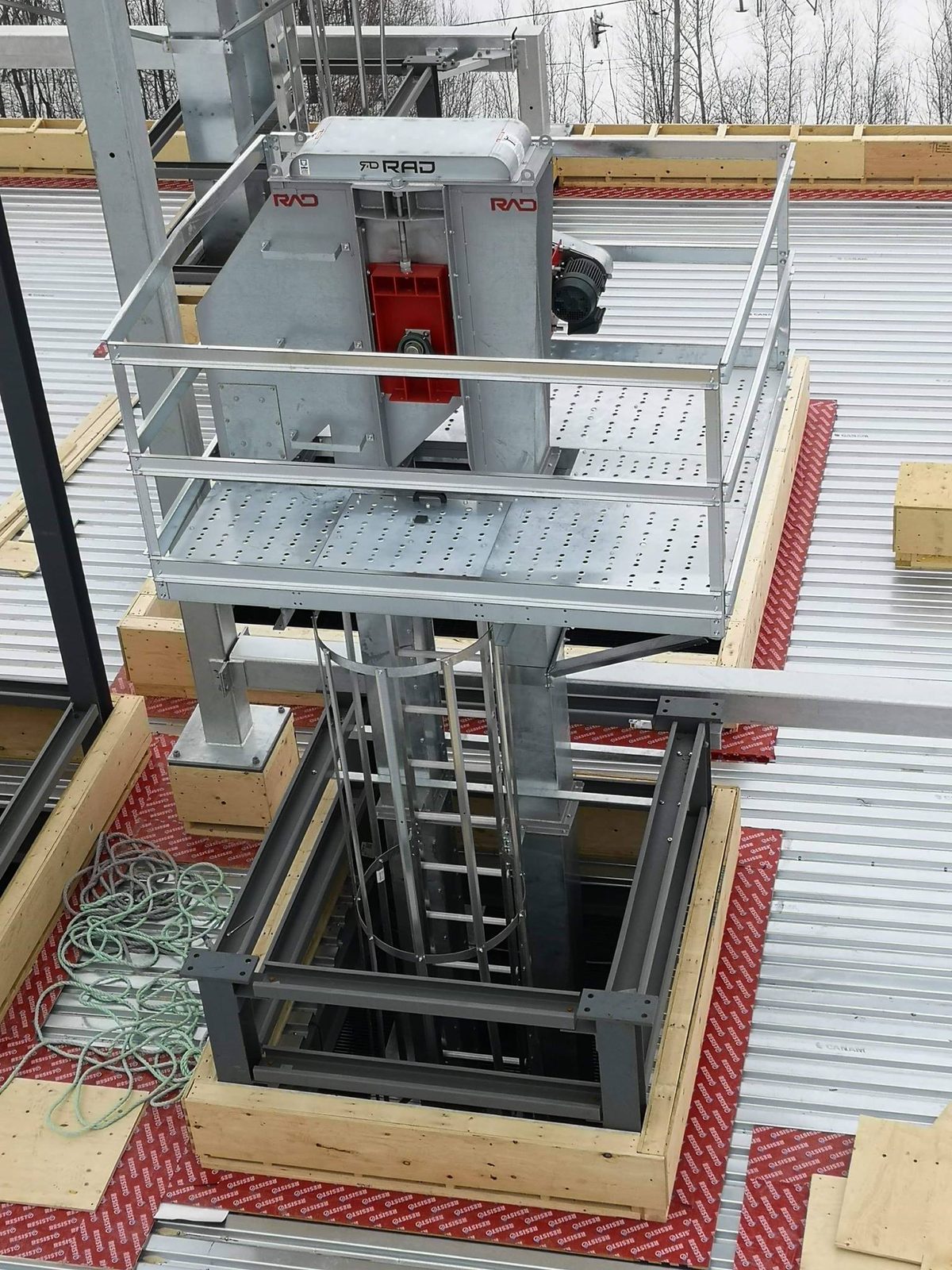 RAD bucket elevator and transfer conveyor with galvanized platform and guardrails installed by CFI Industries at Promix Mill in Quebec
